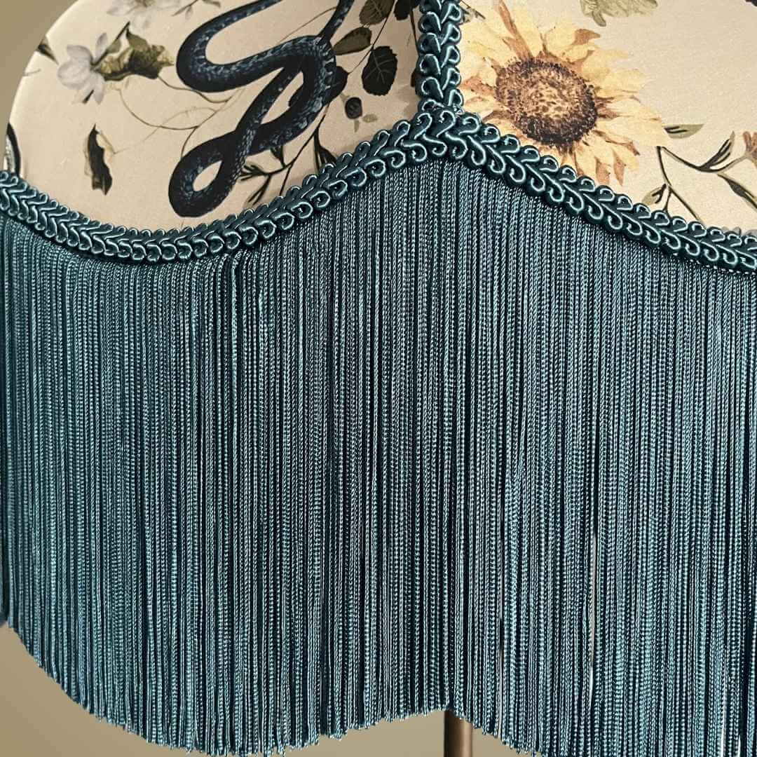Art Deco style lampshade with pretty florals entertwined with snakes and a long blue fringe showing detail