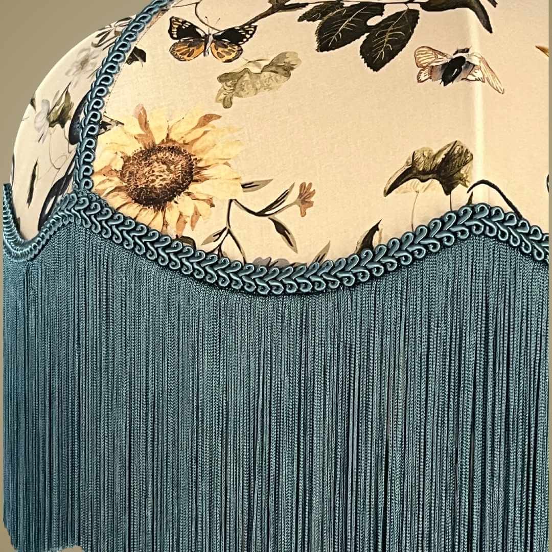 Art Deco style lampshade with pretty florals entertwined with snakes and a long blue fringe showing detail