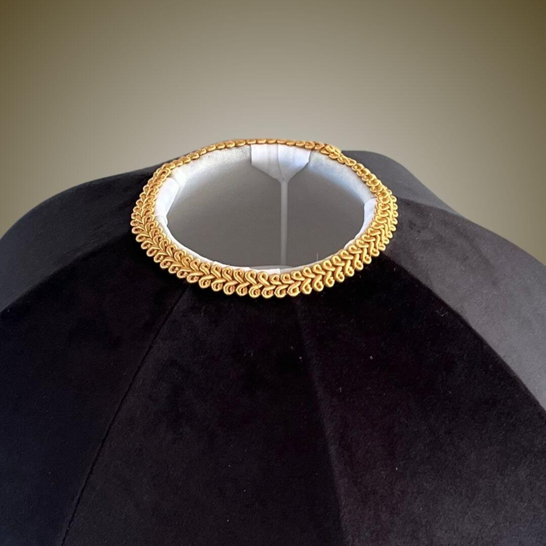 Close up of feather braid detail on black velvet dome lampshade