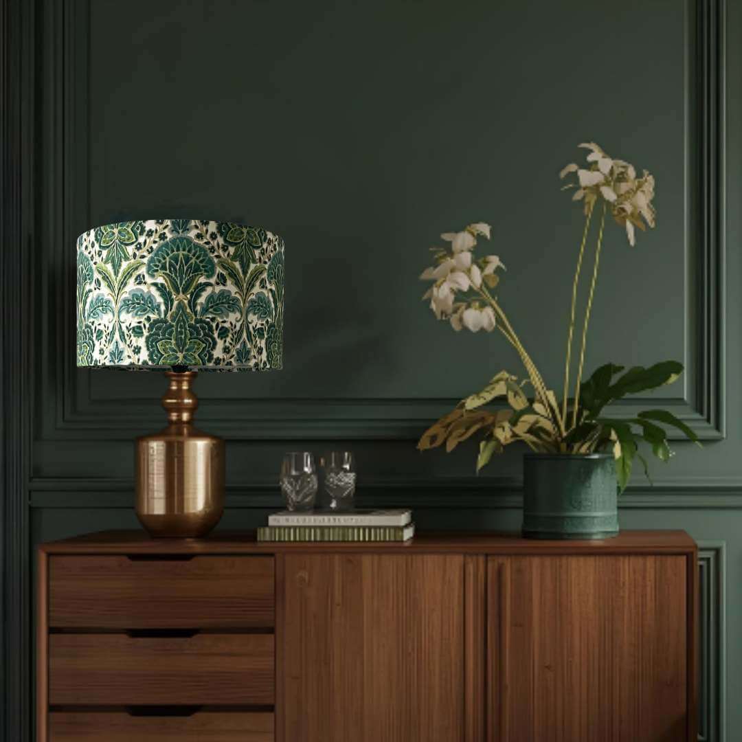 Rhapsody absinthe damask drum lampshade shown on a copper base on a sideboard
