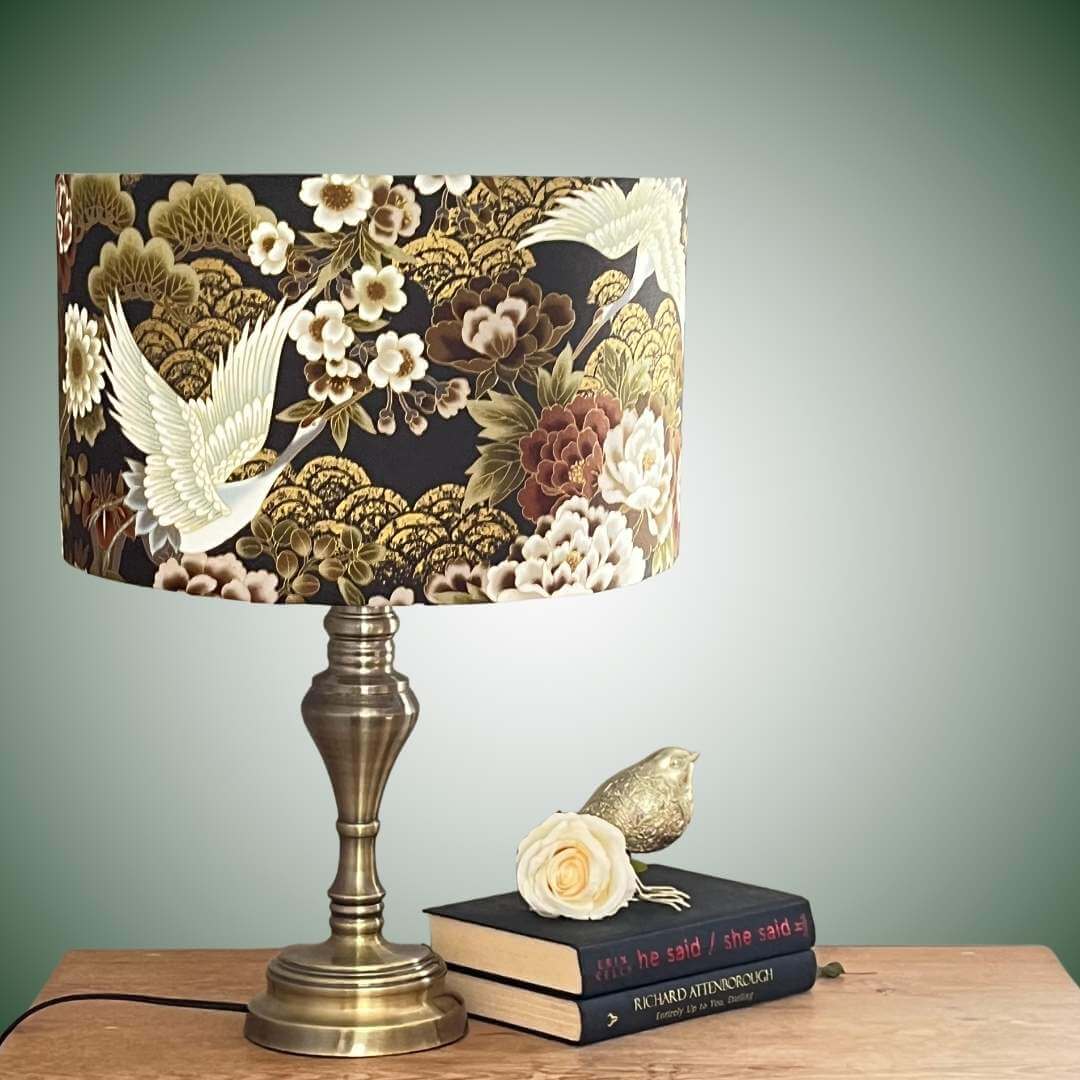 Japanese cranes and florals drum lampshade with metallic accents on table