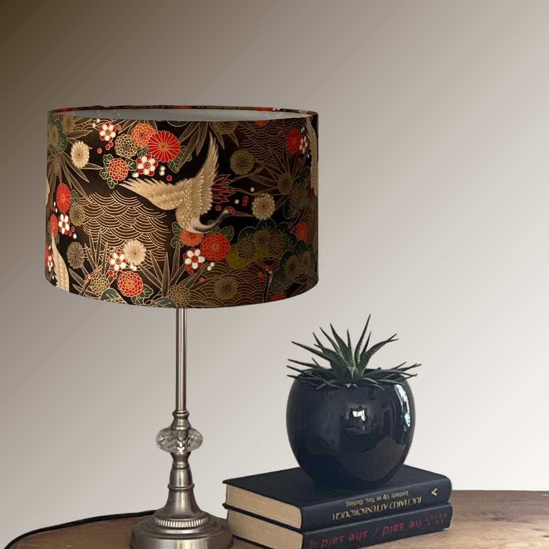 Drum Lampshade made with Authetic Japanese fabric with cranes, florals and metalic gold accents on console