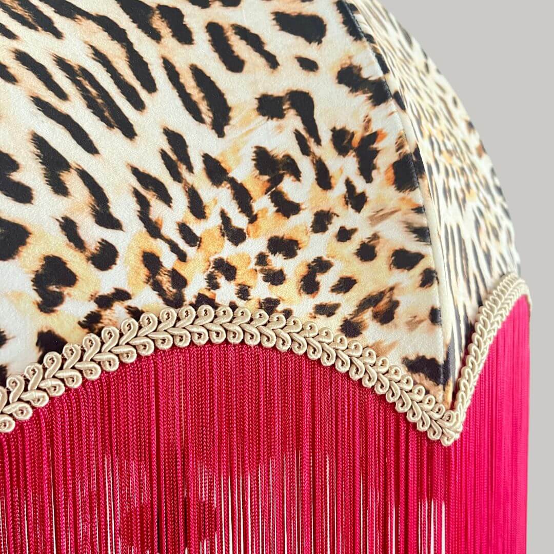 Leopard print dome lampshade with a hot pink fringe close up