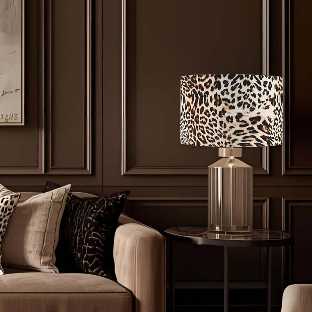 Leopard print lamp on a side table in a room with chocolate panelled walls and a sofa.