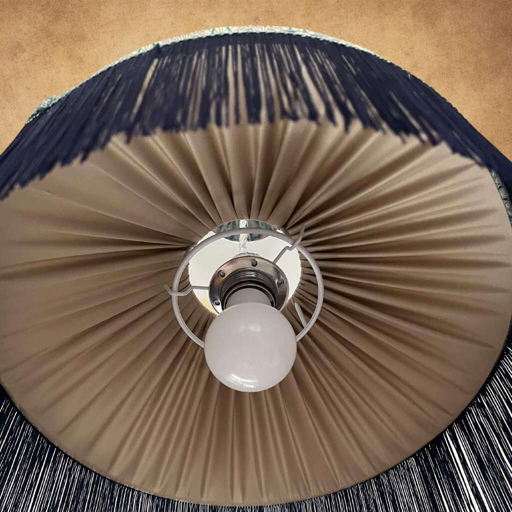 Tiffany style lampshade showing gold pleated lining