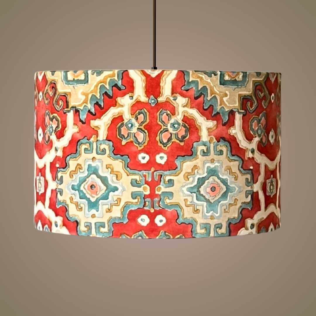 Decorative velvet drum lampshade with a geometric pattern hanging on a pendant