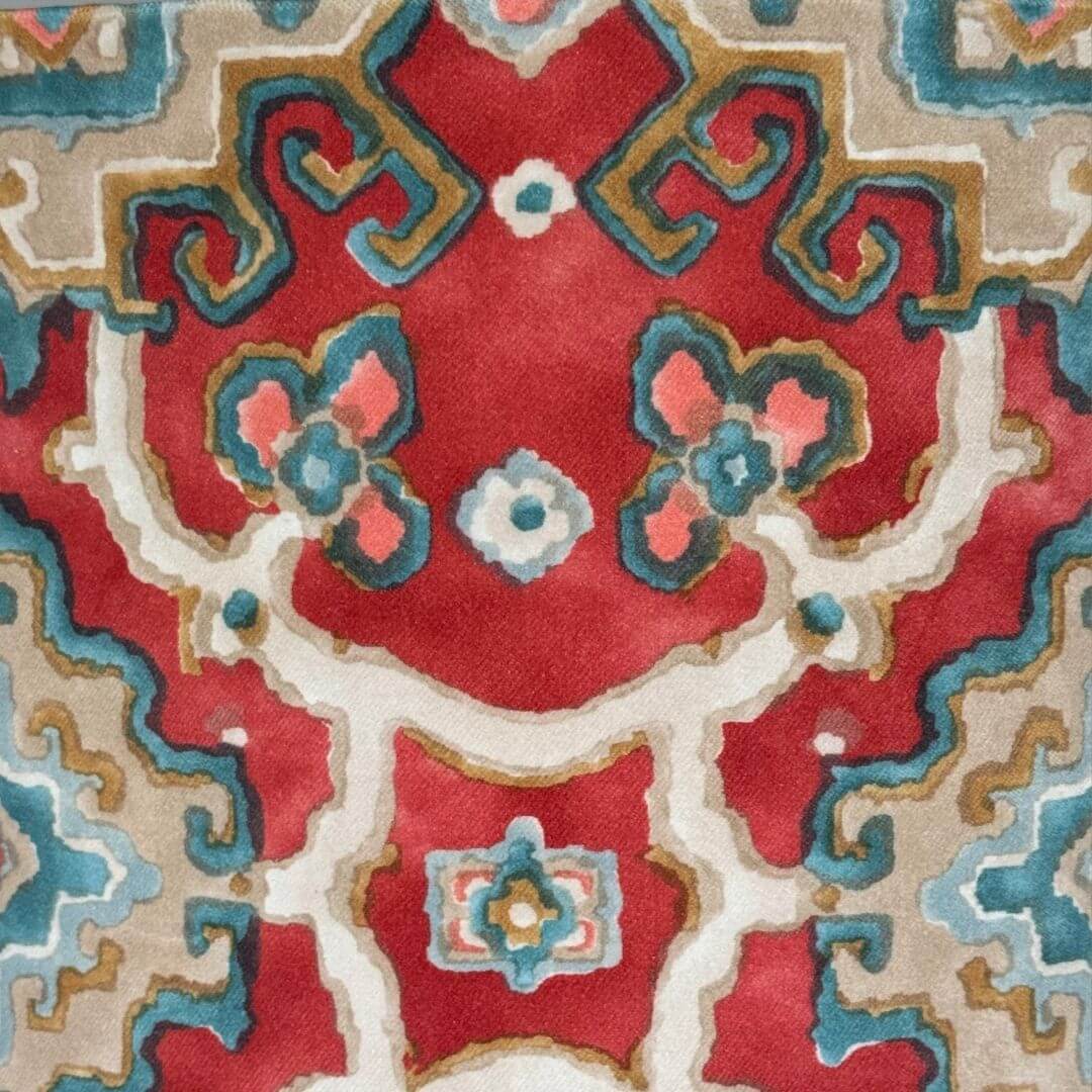 Close-up of a linwood kami chilli geometric patterned fabric with red, blue, and beige colours.