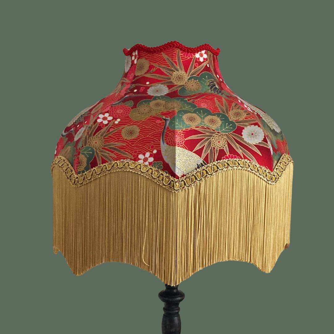 Ornate vintage style lampshade with gold fringe and red japanese fabric with cranes, florals and gold metalic accents