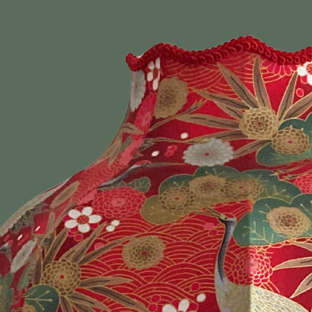 Ornate vintage style lampshade with gold fringe and red japanese fabric with cranes, florals and gold metalic accents top detail