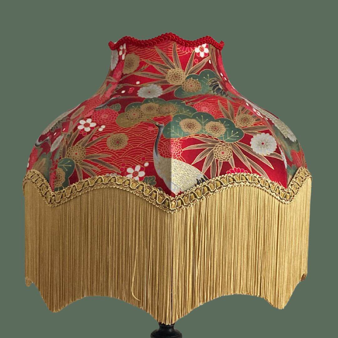 Ornate vintage style lampshade with gold fringe and red japanese fabric with cranes, florals and gold metalic accents