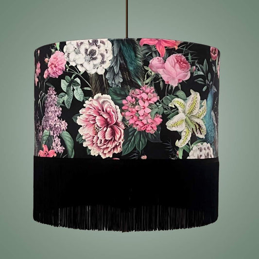 Velvet drum lampshade on a pendant in a Romantic design with peacocks and lush floral blossoms on a black background with fringe