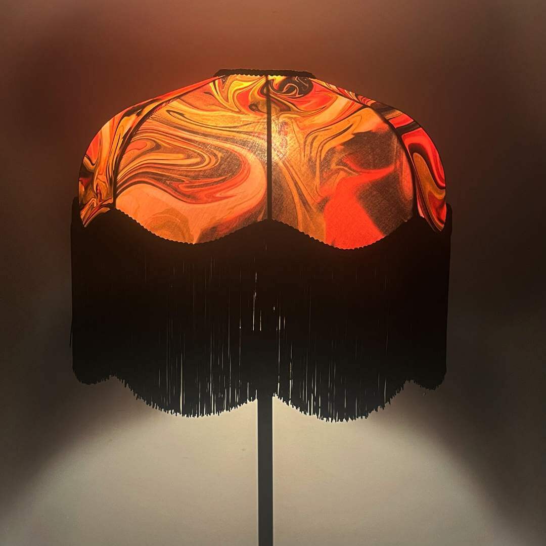 Raspberry Pink & dirty lime marble art deo style lampshade with black fringe shown illuminated