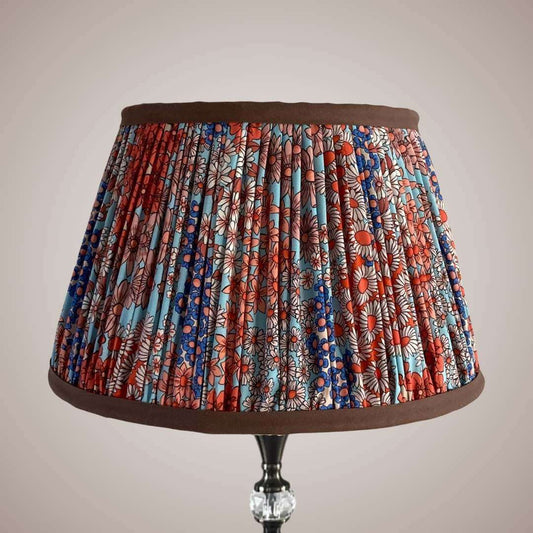 Pleated lampshade in liberty style fabric small florals in orange, blue & turquoise with chocolate brown trim top and bottom details
