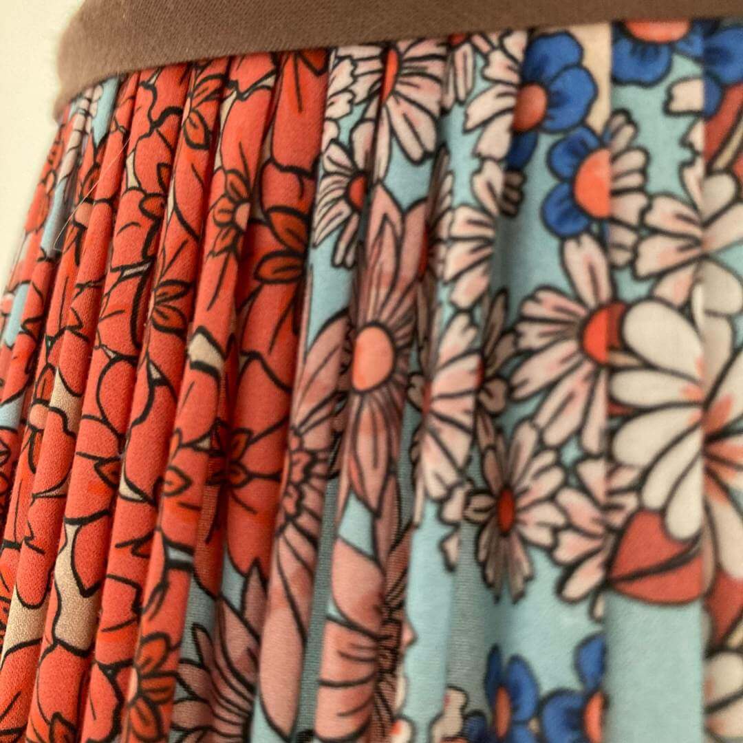 Pleated lampshade in liberty style fabric small florals in orange, blue & turquoise with chocolate brown trim top and bottom details