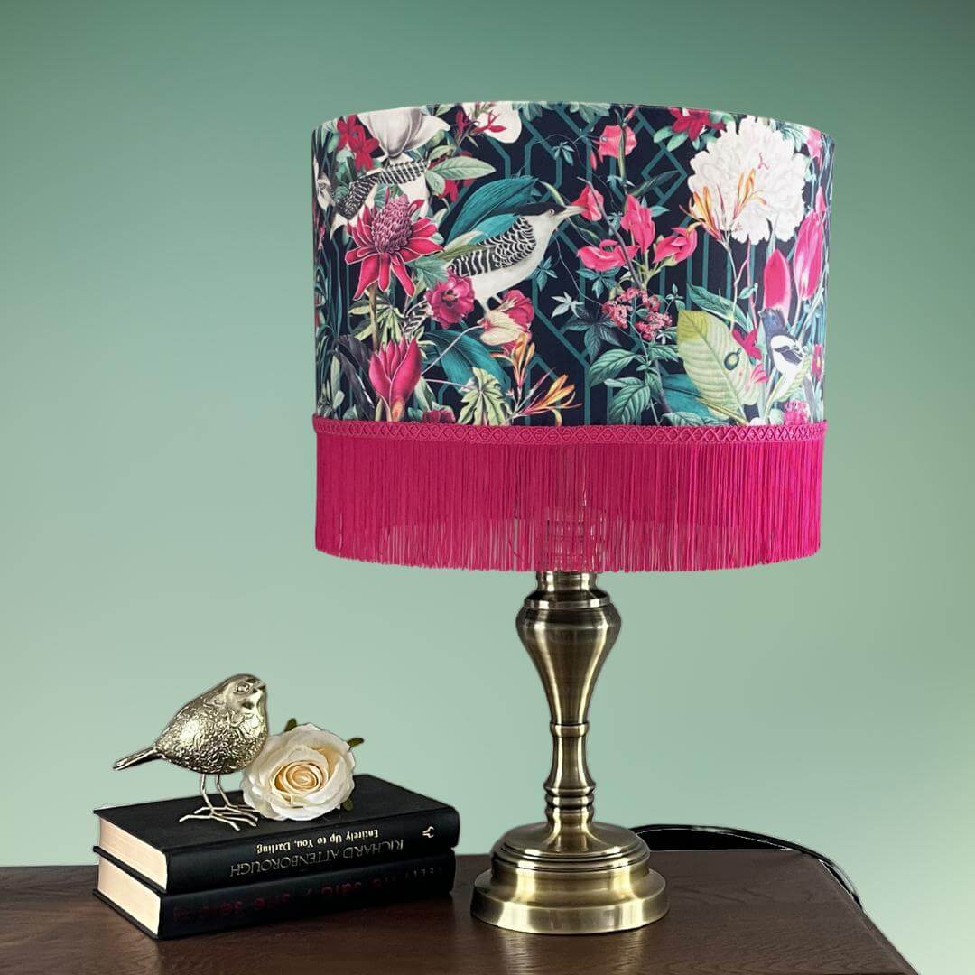 Jungle birds and florals lampshade with hot pink fringe on lamp stand