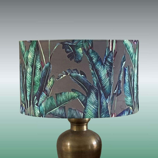 Tropical-palm-leaves-drum-lampshade-on-brass-lamp