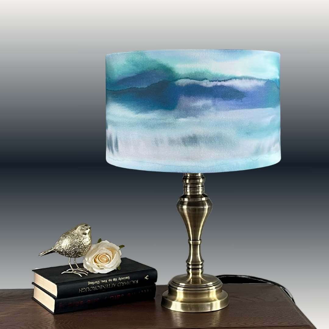 Voyage Maison Fjord Cobalt Drum lampshade on a brass table lamp