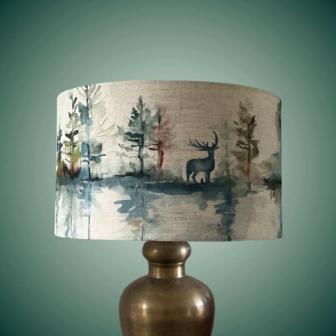 Drum lampshade with highland forest scene & stags on a brass lamp base
