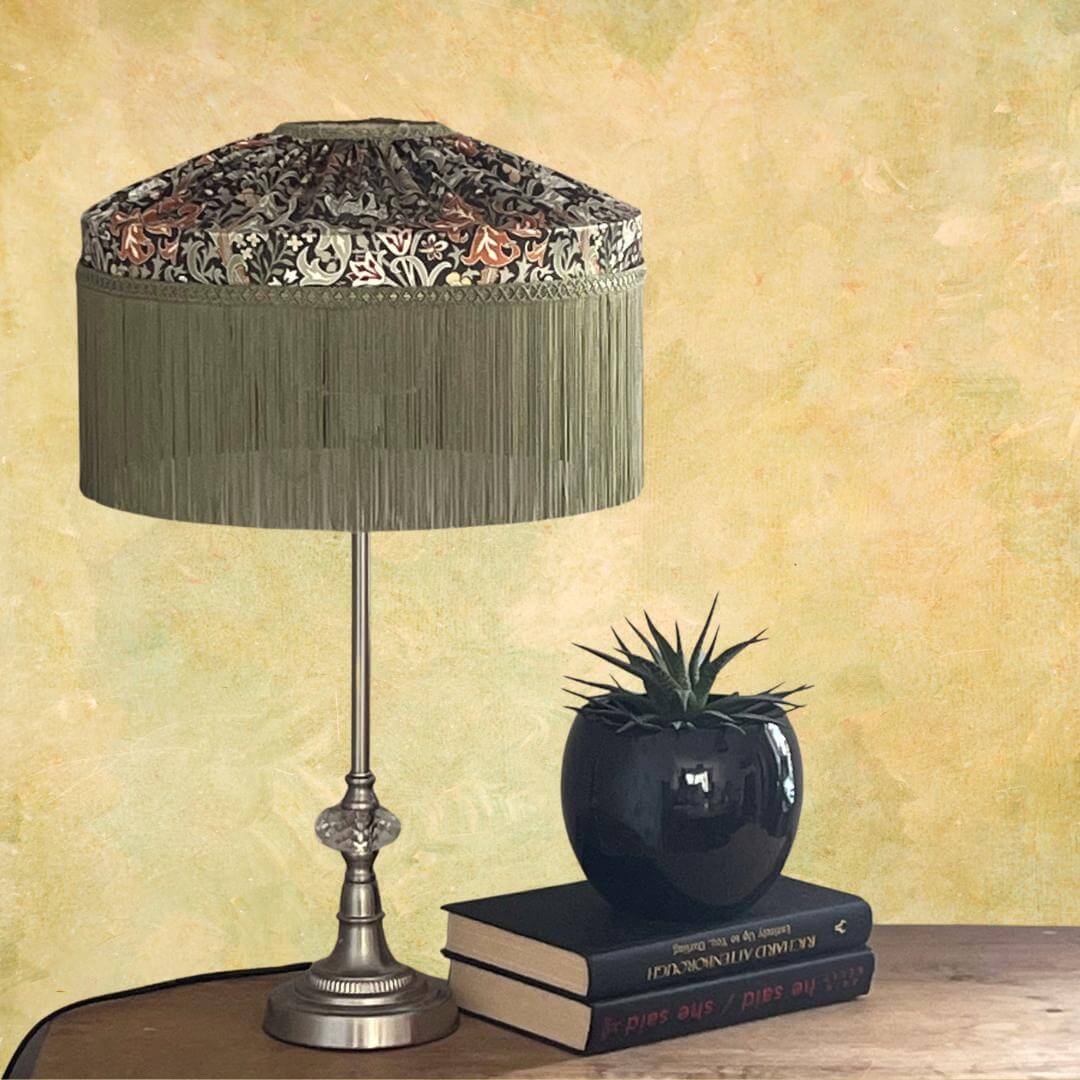 William Morris Golden Lily Satin Tiffany style lampshade with sage fringe styled on a stable