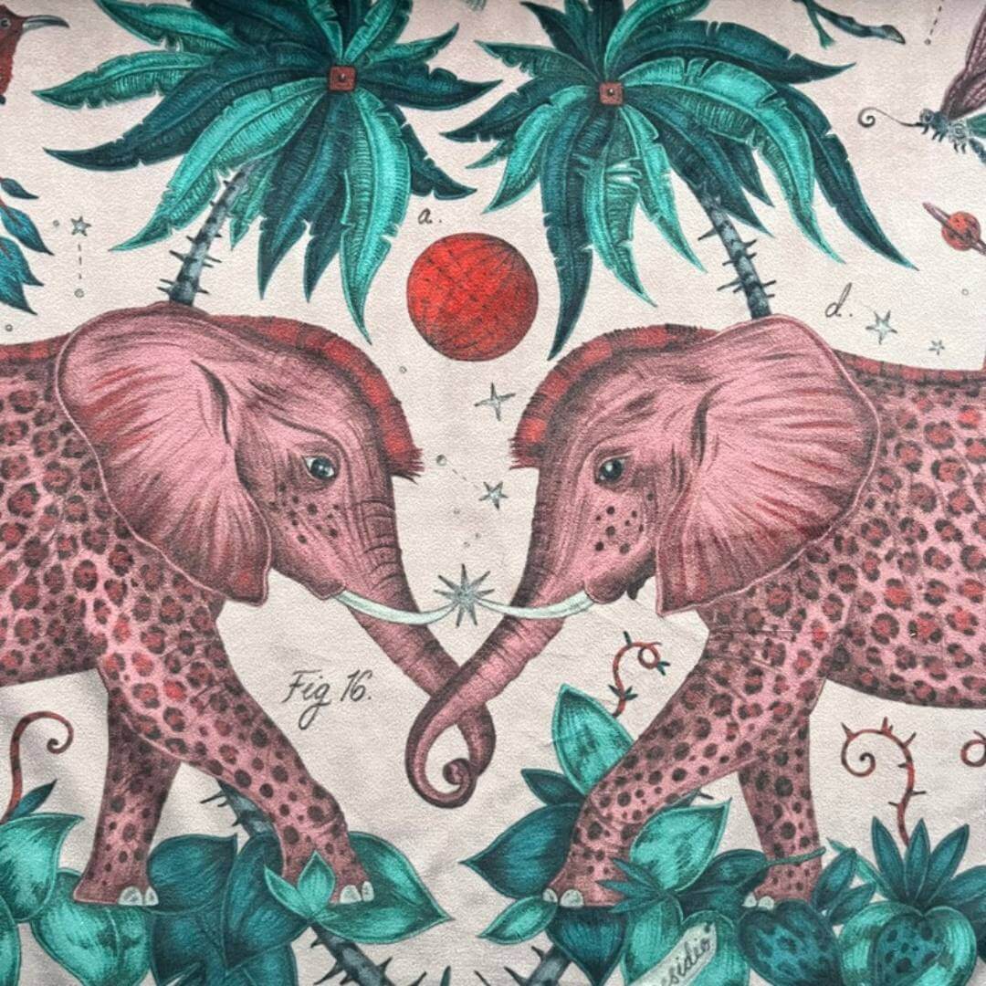 Emma Shipley zambezi design fabric with elephants and jungle foliage on a pink velvet background