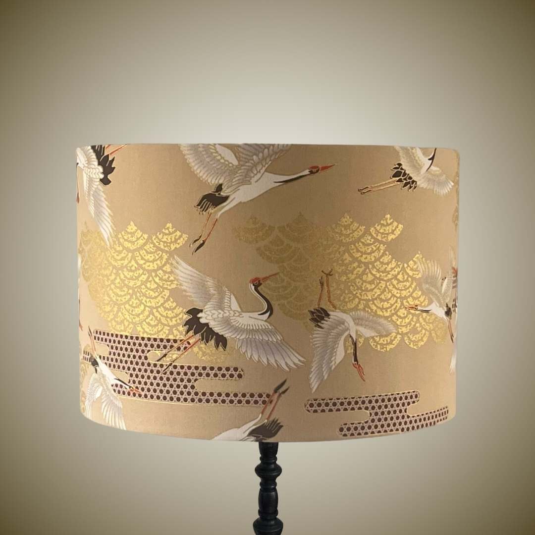 Lampshade featuring cranes in flight and Art Deco style clouds in beige, white, red and gold