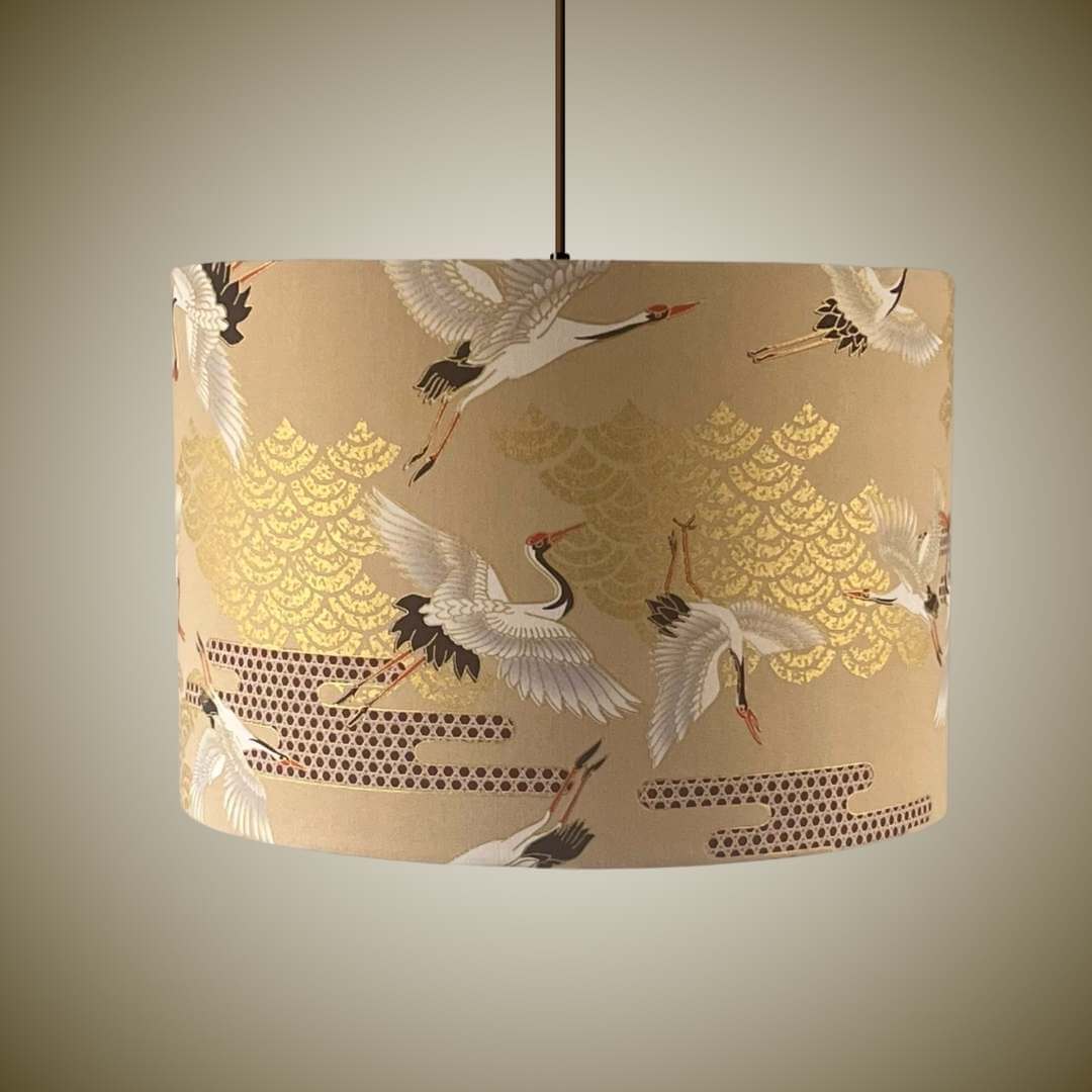 Lampshade featuring cranes in flight and Art Deco style clouds in beige, white, red and gold