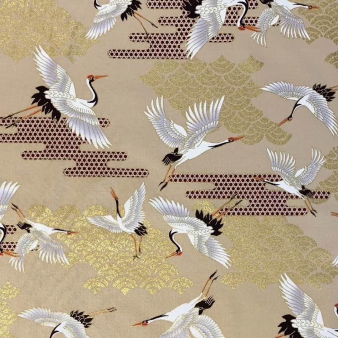 fabric featuring cranes in flight and Art Deco style clouds in beige, white, red and gold