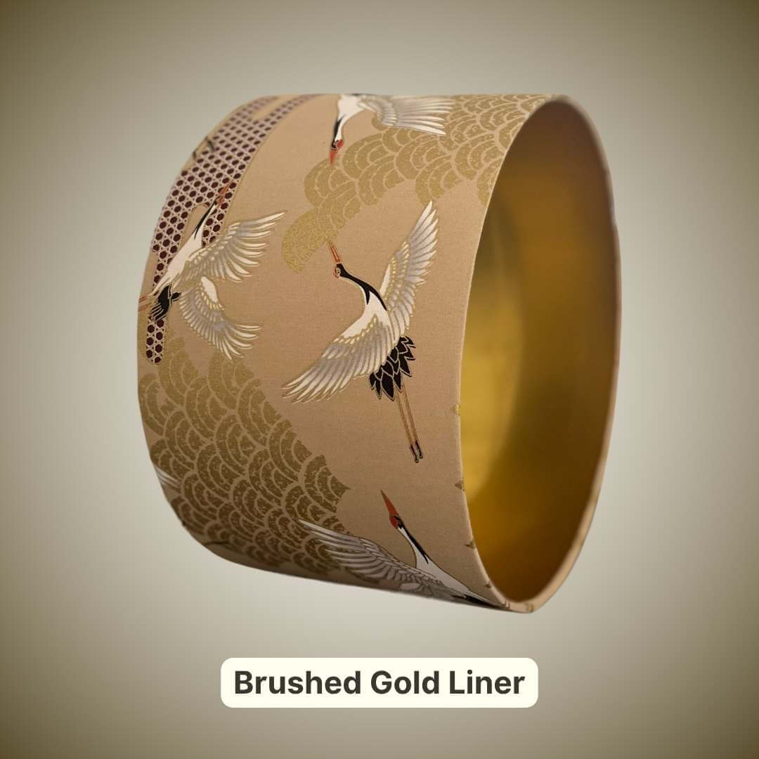 Lampshade featuring cranes in flight and Art Deco style clouds in beige, white, red and gold with a gold liner