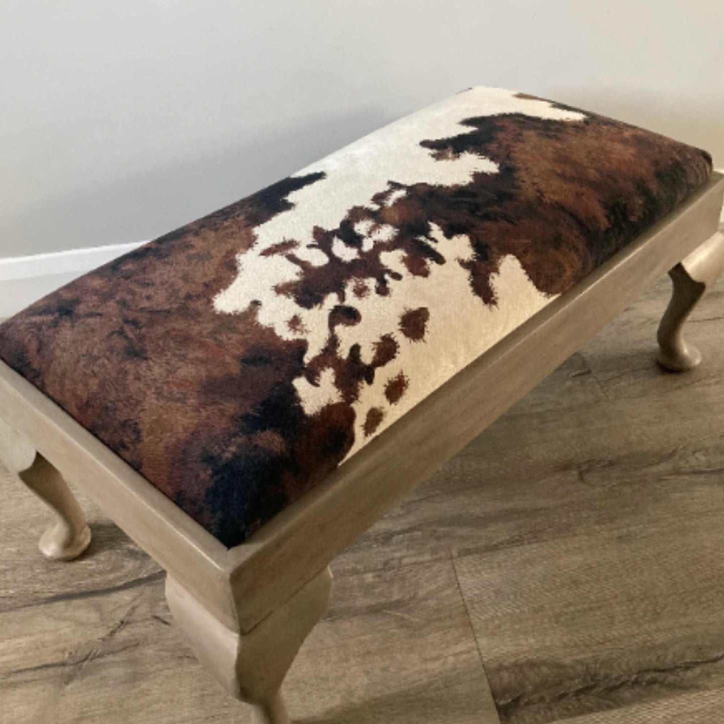 vintage footstool restored and reupholstered in luxury cowprint velvet
