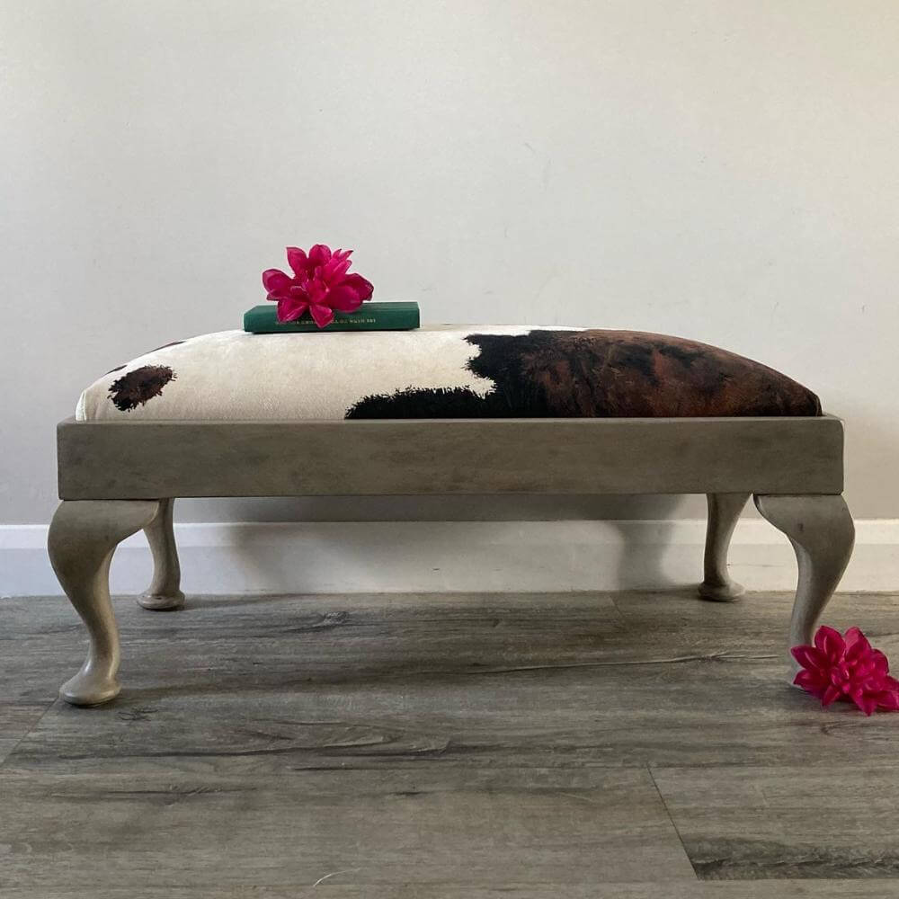 vintage footstool restored and reupholstered in luxury cowprint velvet