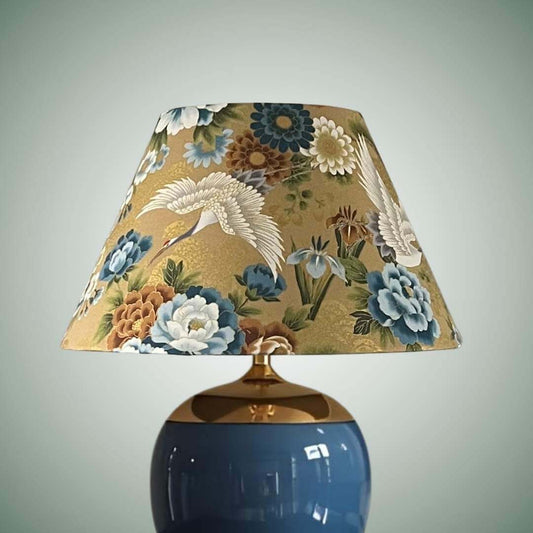 Conical lampshade in Japanese cranes fabric with blue and bronze florals on a gold background