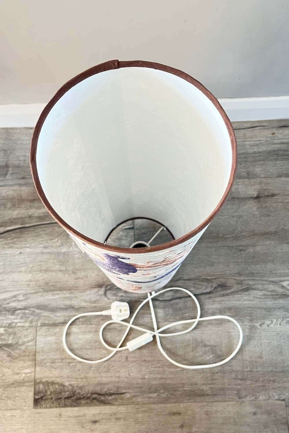 Tall floor lamp with large scale peacock design view of bulbholder