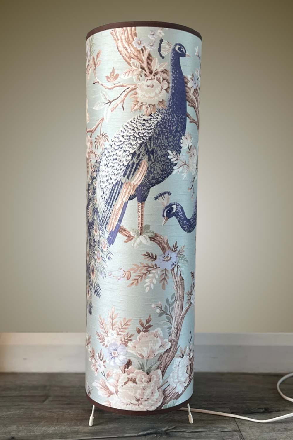 Tall floor lamp with large scale peacock design