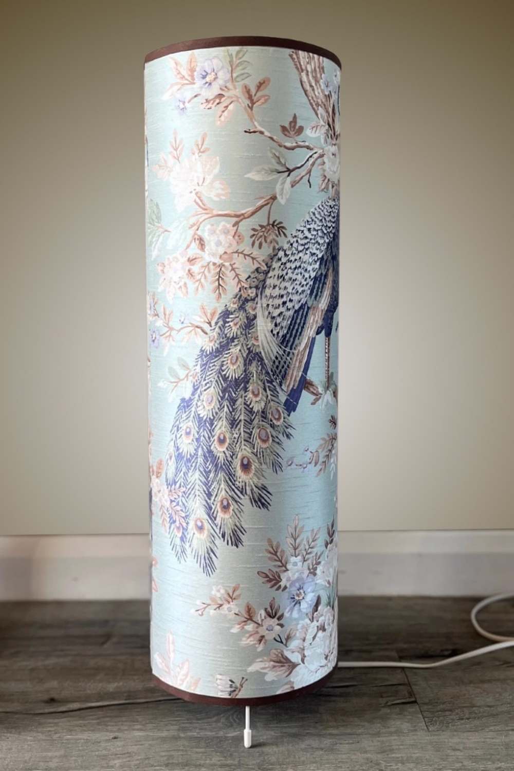 Tall floor lamp with large scale peacock design