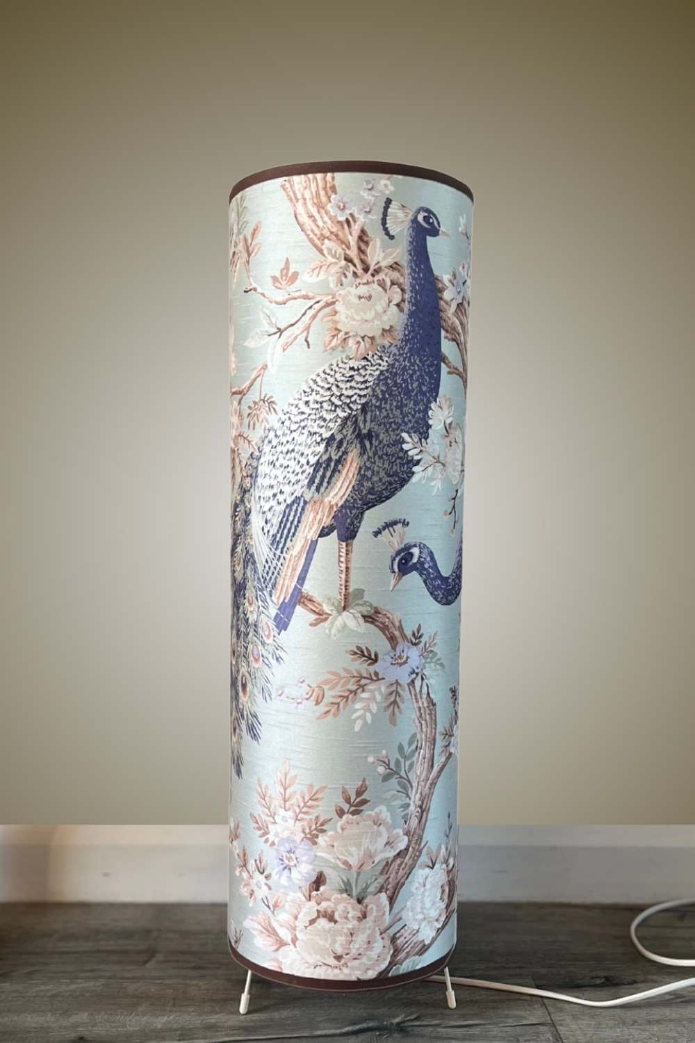 Tall floor lamp with large scale peacock design