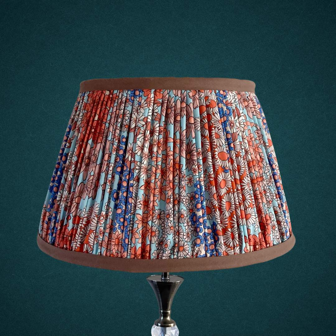 Pleated lampshade in liberty style fabric small florals in orange, blue & turquoise with chocolate brown trim top and bottom