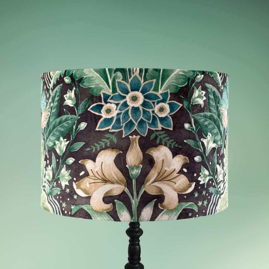 Drum lampshade with bold green floral pattern in a william morris style on black base