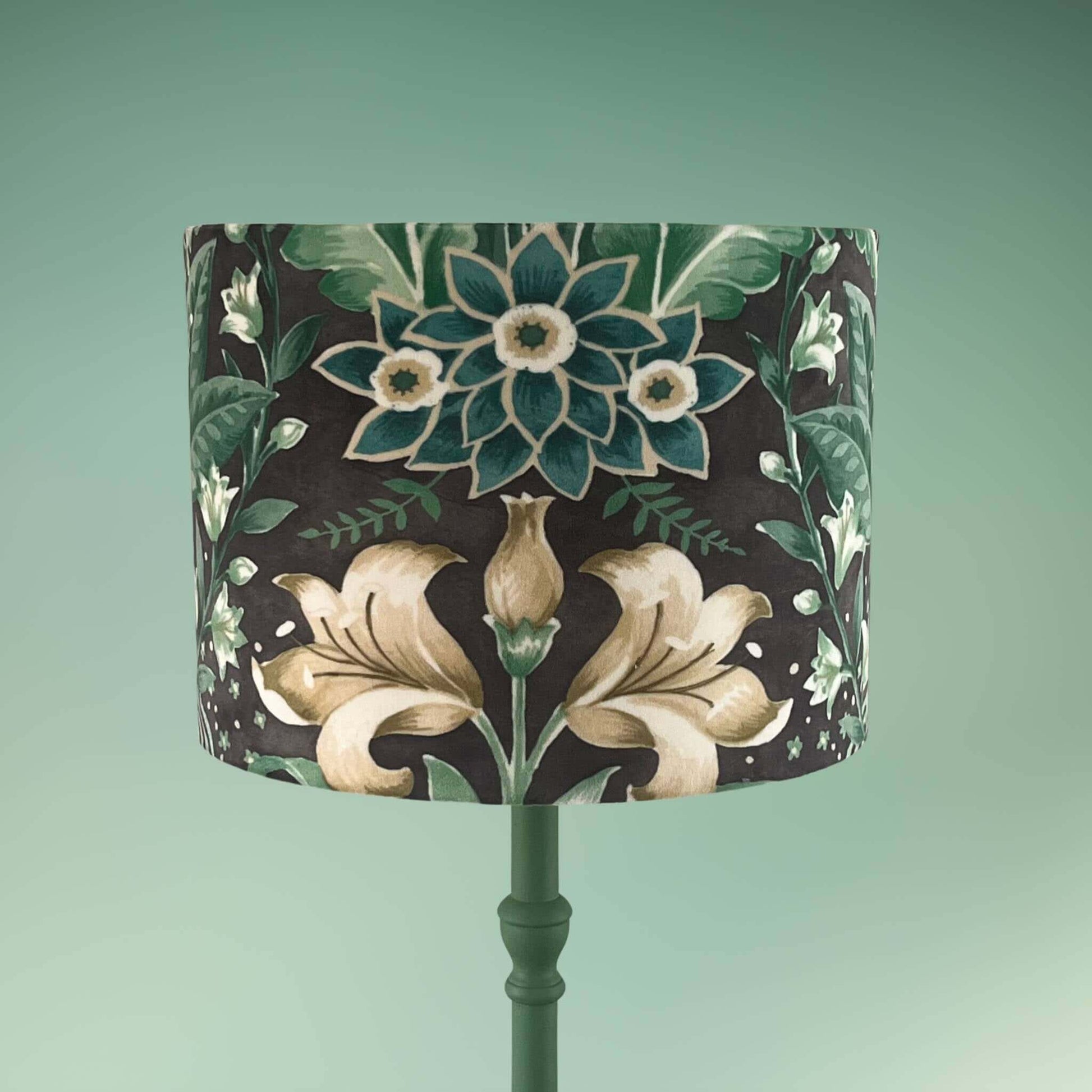 Drum lampshade with bold green floral pattern in a william morris style on green lamp base