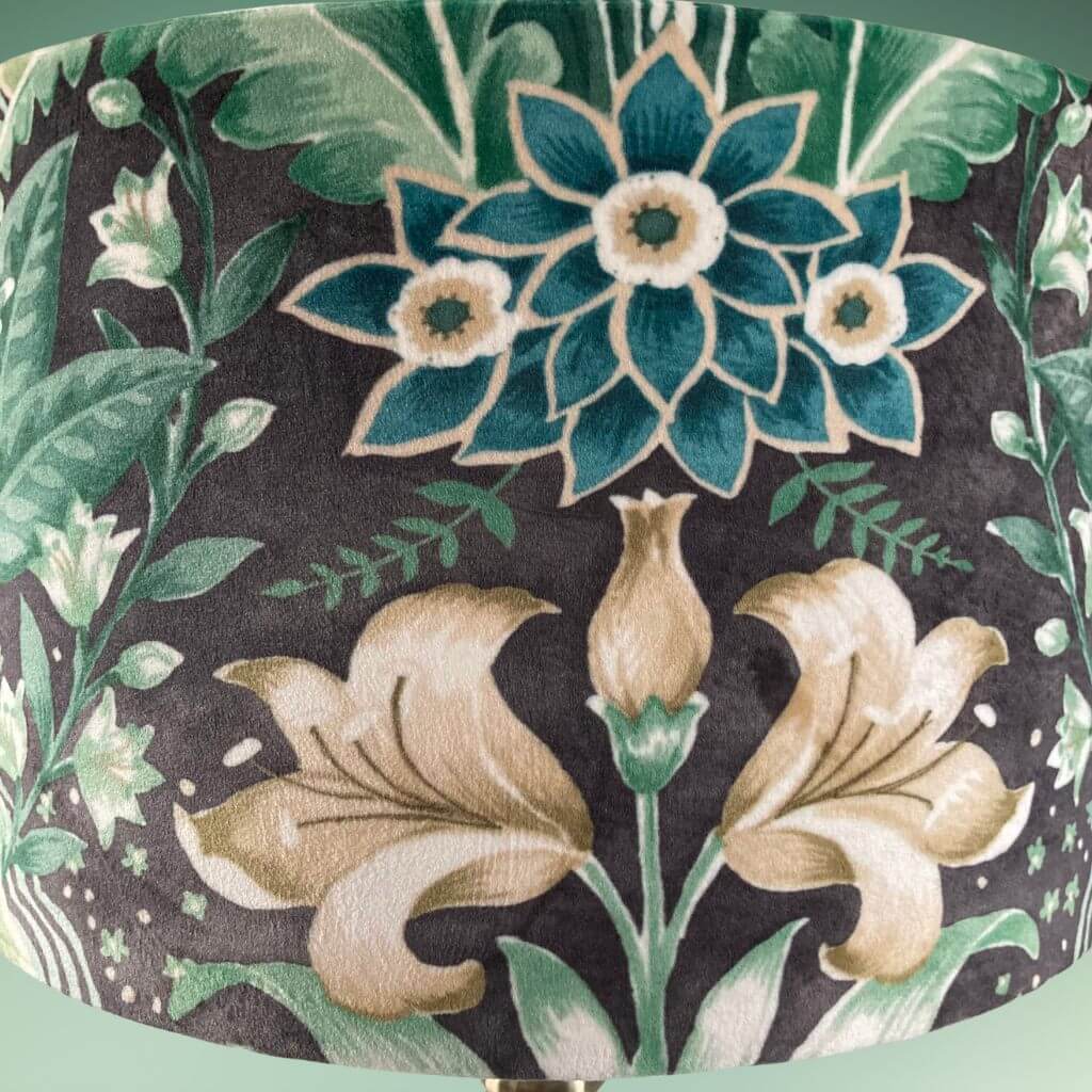 Drum lampshade with bold green floral pattern in a william morris style close up of florals