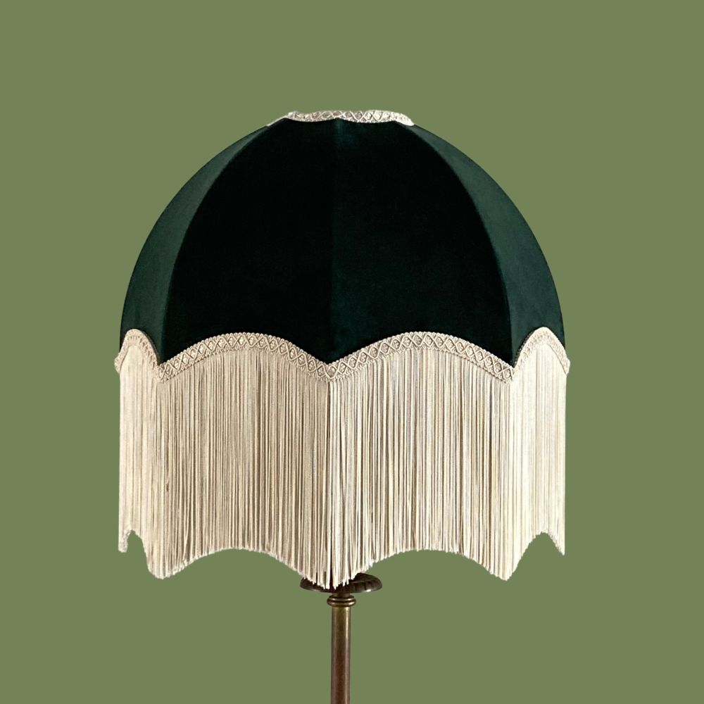 Dark green velvet vintage style dome or parachute lampshade with a deep ivory fringe on a thin stemmed lamp