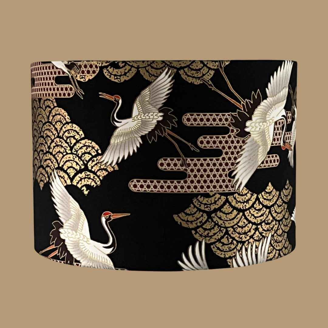 Art Deco style Japanese Cranes Lampshade that features cranes in flight and Art Deco-style clouds on a black background with gold metallic highlights