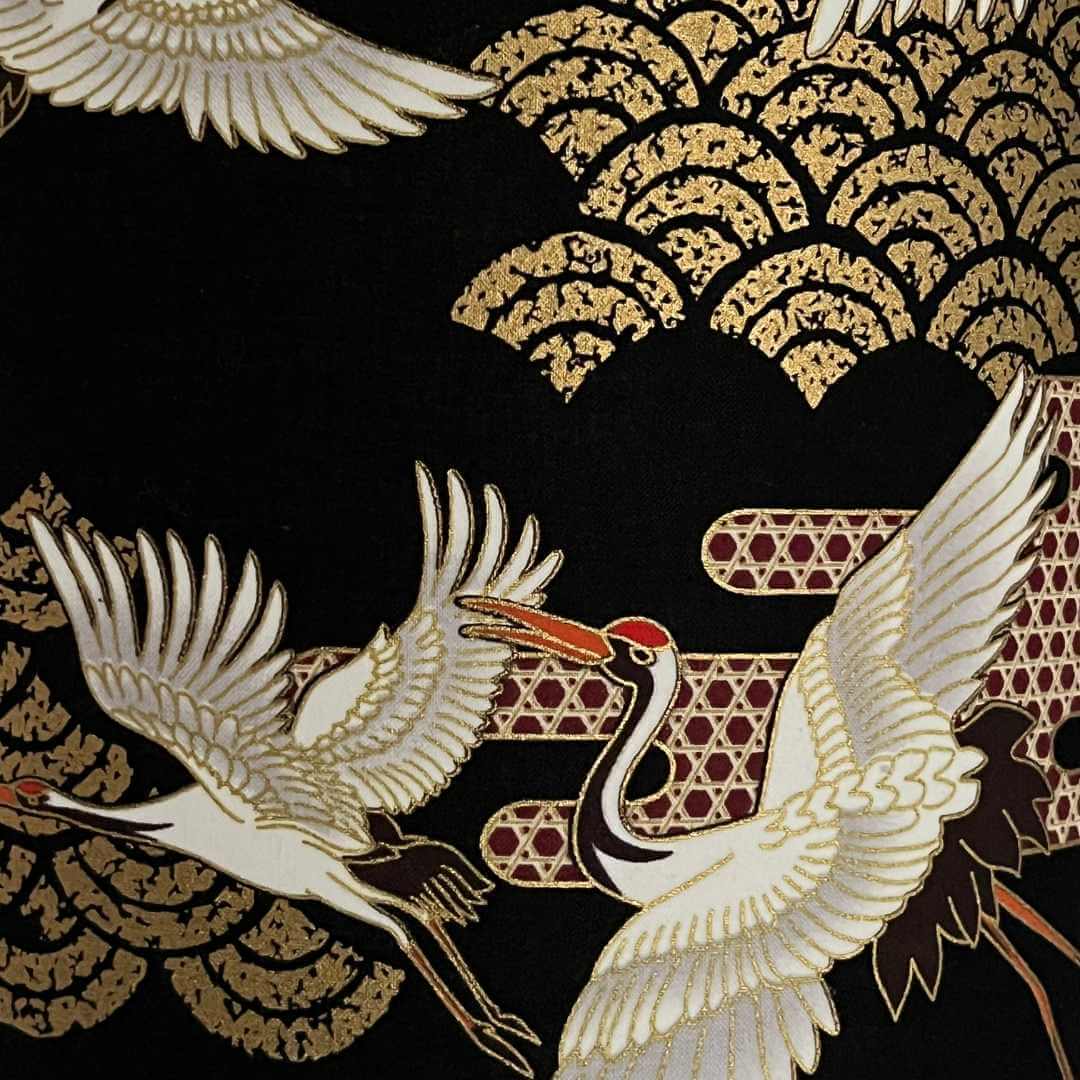 Close-up of Art Deco style Japanese Cranes Lampshade that features cranes in flight and Art Deco-style clouds on a black background with gold metallic highlights