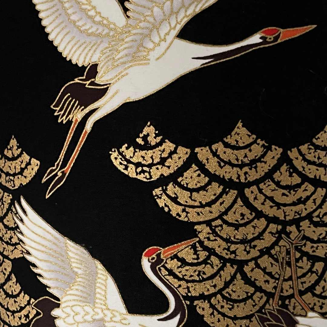 Close up of Art Deco style Japanese Cranes Lampshade that features cranes in flight and Art Deco-style clouds on a black background with gold metallic highlights