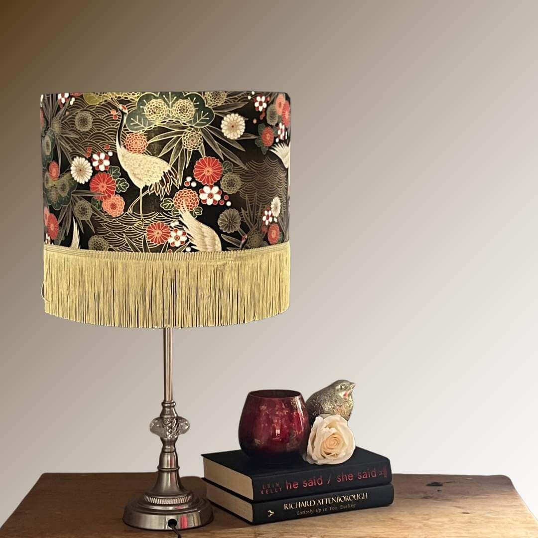 Drum Lampshade made with Authetic Japanese fabric with cranes, florals, metalic gold accents & gold fringe styled on console table