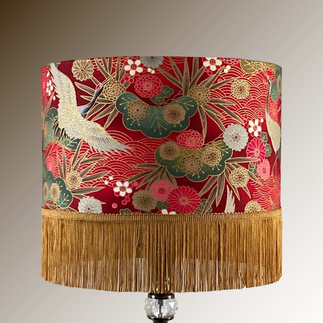 Drum Lampshade made with Authetic Japanese fabric with cranes, florals, metalic gold accents and gold fringe on lampstand