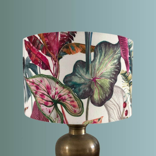 Lampshade with a colorful leaf pattern on a plain white background on brass lamp
