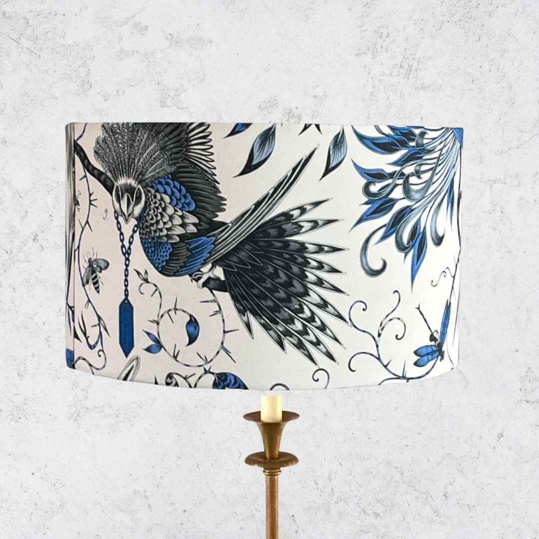 Emma J Shipley Audubon Drum Lampshade featuring exotic birds and foliage in shades of blue on a white background 