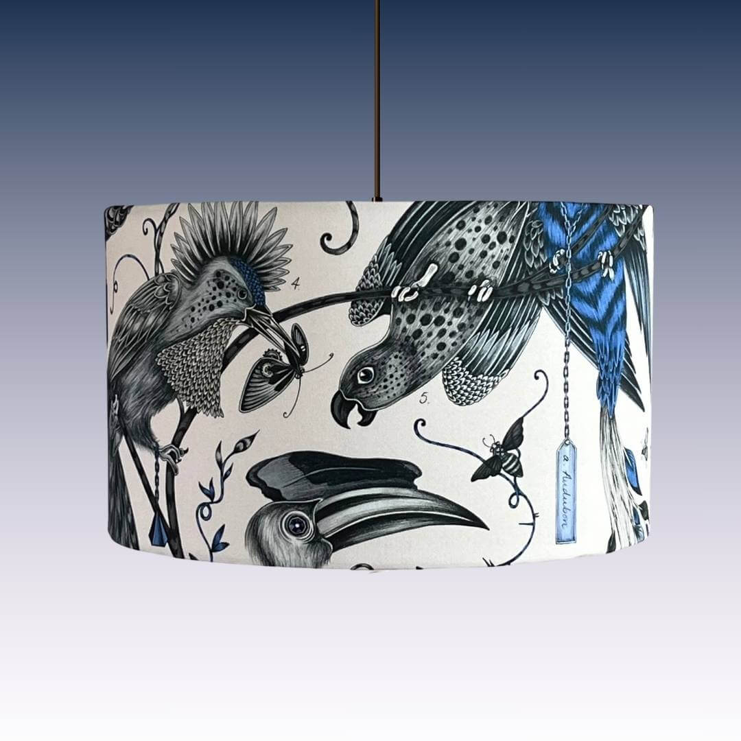 Emma J Shipley Audubon Drum Lampshade on a pendant featuring exotic birds and foliage in shades of blue on a white background 