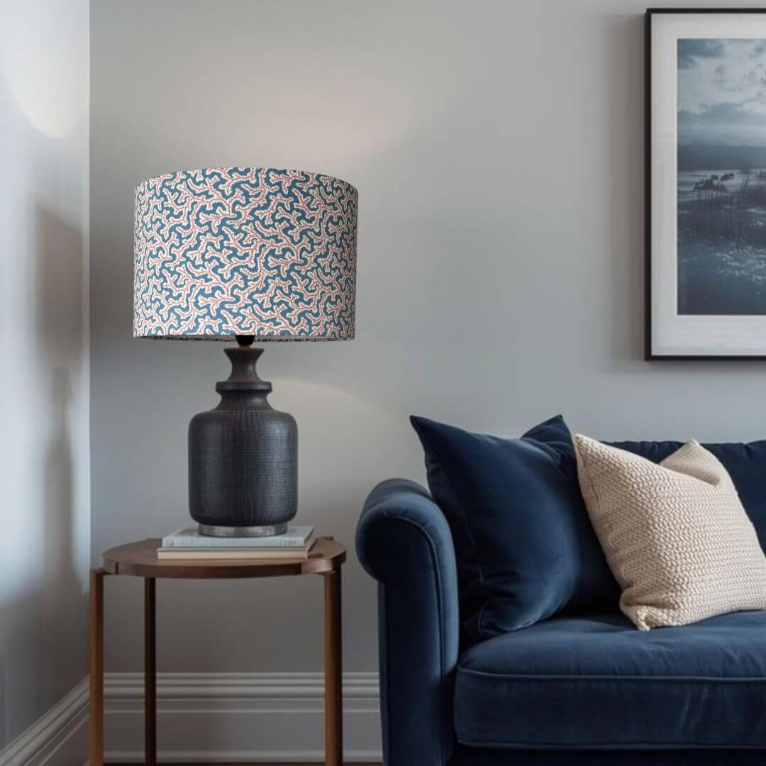 Drum lampshade made with Ian Sanderson Jubilee fabric a small print design based on a seaweed pattern shown in a modern living room setting