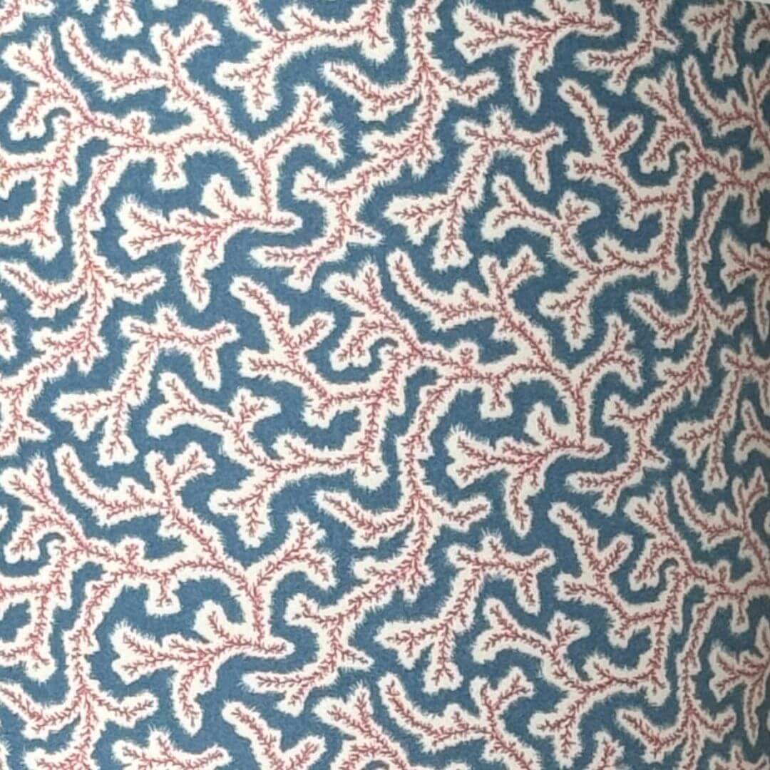 Ian Sanderson Dulcie Jubilee; patterned fabric in red and white design on a blue background 